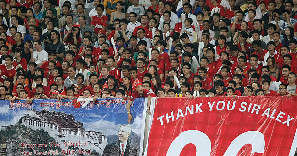 Manchester United fans in China holding up a mural.