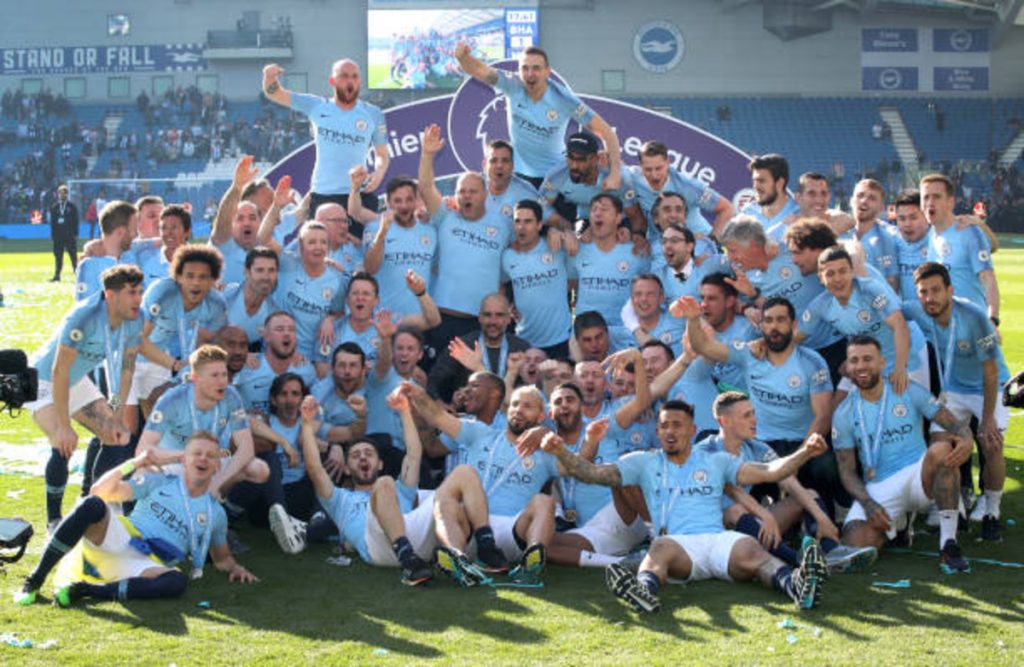 Manchester City celebrate winning the title at Brighton. 